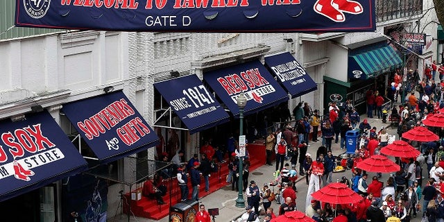 The owner of the Boston Red Sox said he will ask the city to rename Yawkey Way, a street that he called a haunting reminder of the ballclub's history of racial intolerance.