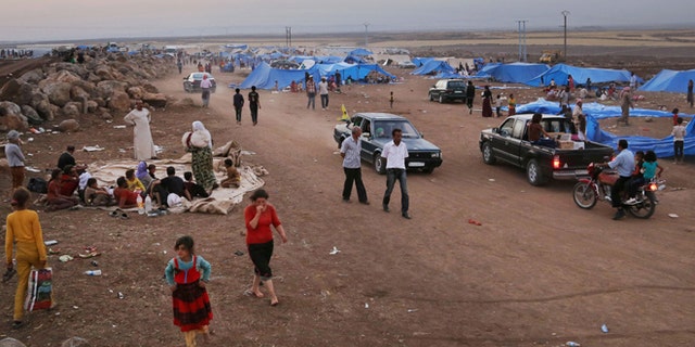 Aug. 10, 2014: Displaced Iraqis from the Yazidi community settle at a camp at Derike, Syria.