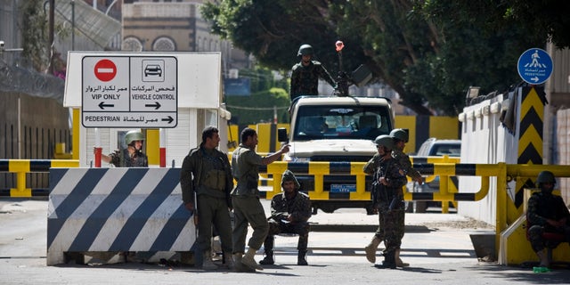 Jan. 17, 2015: Soldiers stand guard at the gate of the French Embassy, as Yemenis protest against caricatures published in French magazine Charlie Hebdo in front of the embassy in Sanaa, Yemen.
