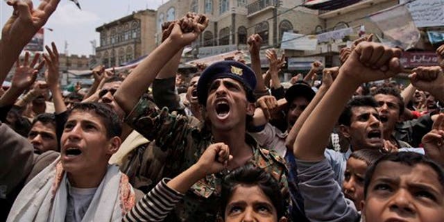 June 29: Anti-government protestors, shout slogans during a demonstration demanding the resignation of Yemeni President Ali Abdullah Saleh, in Sanaa, Yemen. Yemeni government warplanes and artillery pounded several villages of anti-government tribes north of the capital on Tuesday, killing at least three people, a senior tribal leader said.