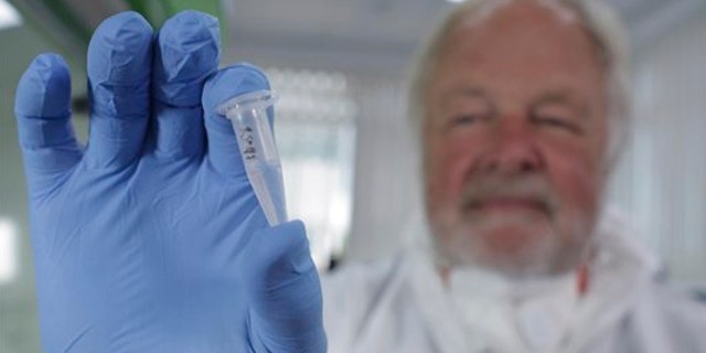 UNDATED: This photo made available by Britain's Channel 4 television shows Oxford University genetics professor Bryan Sykes posing with a prepared DNA sample taken from hair from a Himalayan animal.