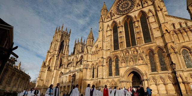 File photo - Members of the clergy enter York Minster before a service to consecrate Reverend Libby Lane as the first female bishop in the Church of England, in York, northern England January 26, 2015. (REUTERS/Phil Noble)