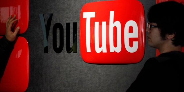 Feb. 14, 2013: Visitors stand in front of a logo of YouTube at the YouTube Space Tokyo, operated by Google, in Tokyo.