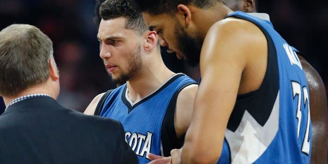 Minnesota Timberwolves guard Zach LaVine is helped off the court during the second half of the team's NBA basketball game against the Detroit Pistons, Friday, Feb. 3, 2017, in Auburn Hills, Mich. (AP Photo/Carlos Osorio)