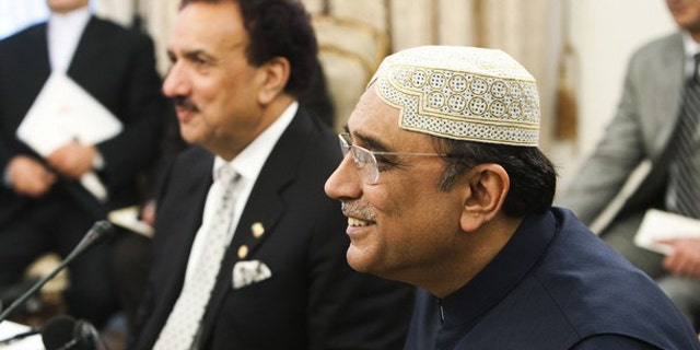 FILE: Pakistani President Asif Ali Zardari, right, and Pakistani Interior Minister Rahman Malik attend a trilateral meeting with their Iranian and Afghan counterparts in Tehran June 24.