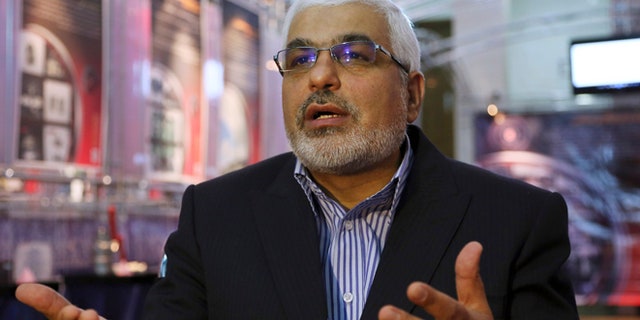 Sept. 1, 2014: Deputy head of the Atomic Energy Organization of Iran Asghar Zarean speaks in an interview with Associated Press as he is seated in a display of various parts and equipment from valves and pumps to electro motors, modems and barometers that they say were exported to the country with alleged purpose of sabotage and spying on Irans nuclear facilities in Tehran, Iran. (AP/Vahid Salemi)