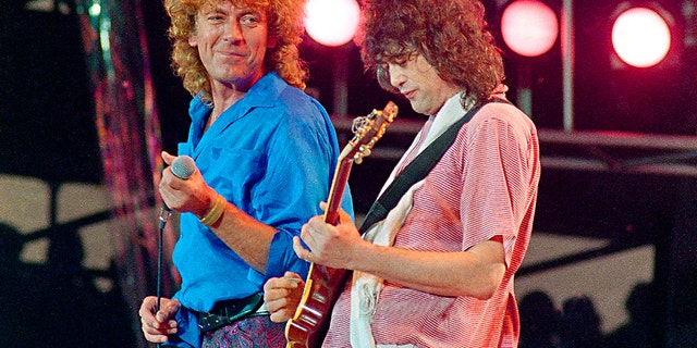 In this July 13, 1985 file photo, Led Zeppelin bandmates, singer Robert Plant, left, and guitarist Jimmy Page, reunite to perform for the Live Aid famine relief concert at JFK Stadium in Philadelphia.