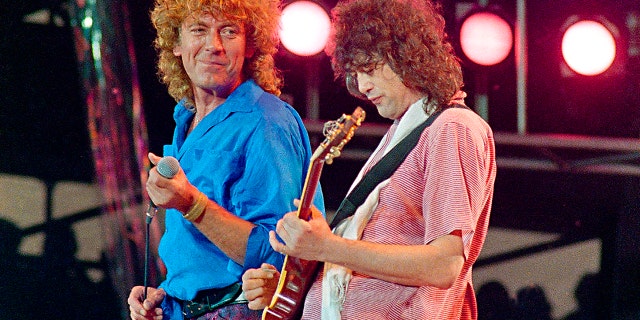In this July 13, 1985 file photo, Led Zeppelin bandmates, singer Robert Plant, left, and guitarist Jimmy Page, reunite to perform for the Live Aid famine relief concert at JFK Stadium in Philadelphia.