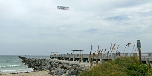An aerial banner is flown over the South Pointe Park pier, Tuesday, Sept. 6, 2016, in the South Pointe Park area in Miami Beach, Fla.