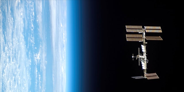 Backdropped by Earth's horizon and the blackness of space, the International Space Station is seen from Space Shuttle Endeavour as the two spacecraft begin their relative separation.
