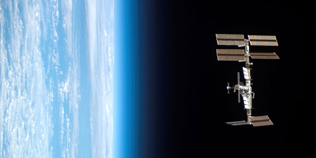 Backdropped by Earth's horizon and the blackness of space, the International Space Station is seen from Space Shuttle Endeavour as the two spacecraft begin their relative separation.