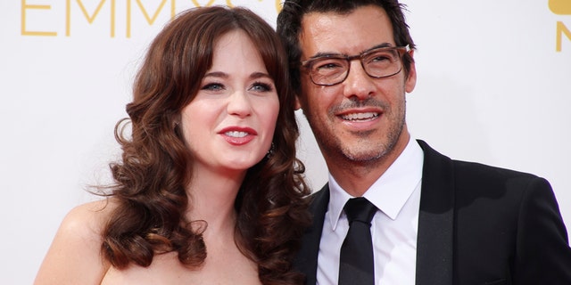 Actress Zooey Deschanel, from the Fox sitcom "New Girl," arrives with Jacob Pechenik at the 66th Primetime Emmy Awards in Los Angeles, California August 25, 2014.