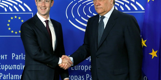 Facebook's CEO Mark Zuckerberg shakes hands with European Parliament President Antonio Tajani at the European Parliament in Brussels, Belgium May 22, 2018.