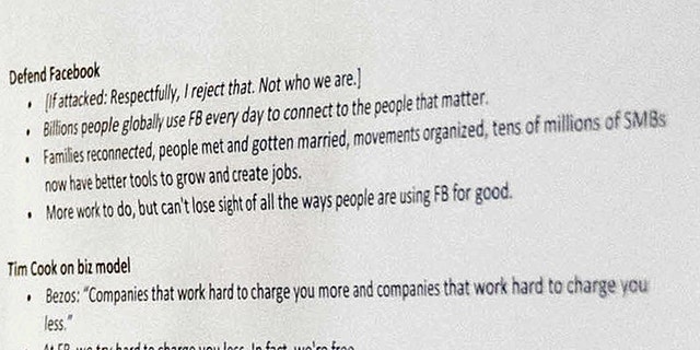 An aide to Facebook CEO Mark Zuckerberg closes a binder of notes left on the table as Zuckerberg takes a short break from testifying before a joint hearing of the Commerce and Judiciary Committees on Capitol Hill in Washington, Tuesday, April 10, 2018, about the use of Facebook data to target American voters in the 2016 election. (AP Photo/Andrew Harnik)