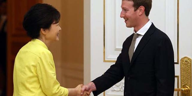 South Korean President Park Geun-hye, left, shakes hands with Facebook CEO Mark Zuckerberg during a meeting at the presidential house in Seoul, South Korea, Tuesday, June 18, 2013.