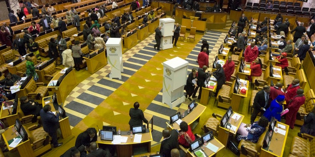 Members of parliament prepare to vote for or against the motion of no confidence against South African president, Jacob Zuma in the South African parliament in Cape Town, South Africa, Tuesday, Aug. 8, 2017.