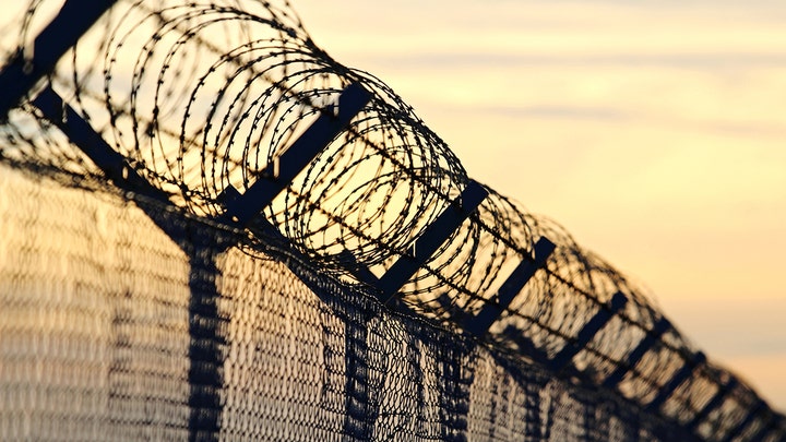 A barbed wire fence around a prison