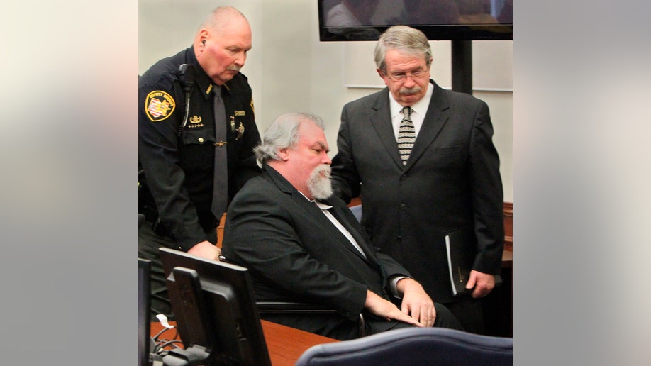 Defense attorney Lawrence J. Whitney (R) accompanies convicted Craigslist murderer Richard Beasley after the jury recommended the death penalty in the courtroom of Summit County in Akron, Ohio, March 20, 2013. The jury took less than three hours to come to a decision recommending the death penalty, and the judge said on Wednesday she will sentence Beasley on March 26. REUTERS/Michael Chritton/Akron Beacon Journal/POOL (UNITED STATES - Tags: CRIME LAW) - RTR3F90K