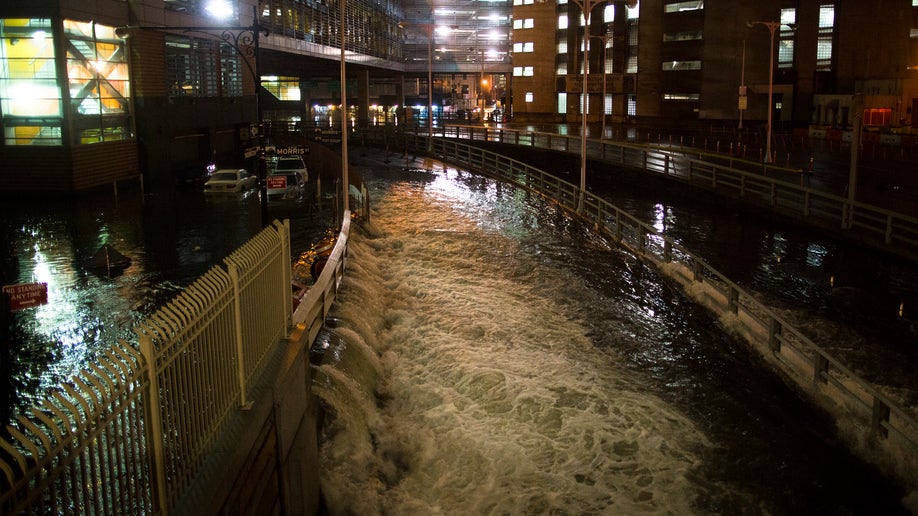 Sea water floods the entrance to the Brooklyn Battery Tunnel, Monday, Oct. 29, 2012, in New York. Sandy continued on its path Monday, as the storm forced the shutdown of mass transit, schools and financial markets, sending coastal residents fleeing, and threatening a dangerous mix of high winds and soaking rain.  (AP Photo/ John Minchillo)