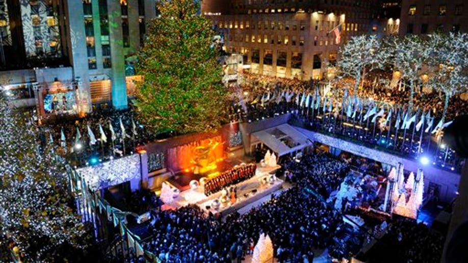 The 74-foot-tall Rockefeller Center Christmas Tree is lit by 30,000 energy efficient LED lights in the 79th annual lighting ceremony, Wednesday, Nov. 30, 2011 in New York. (AP Photo/Henny Ray Abrams)