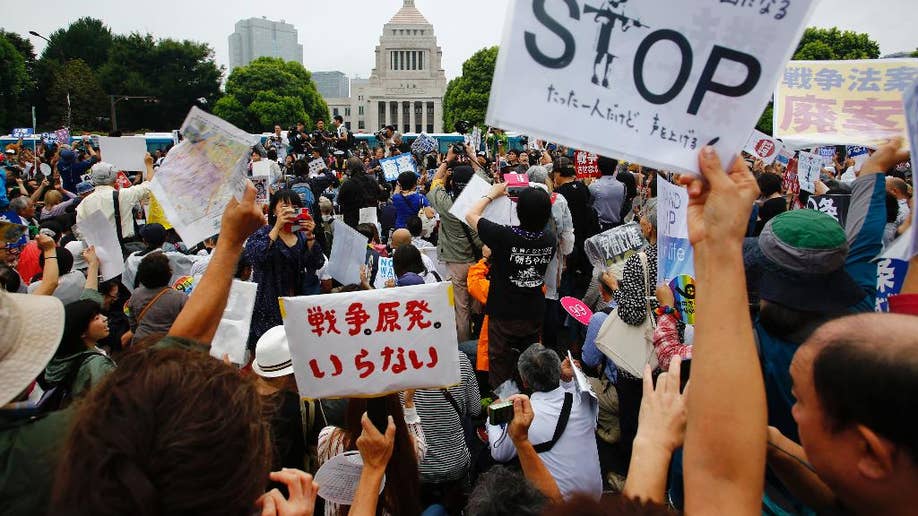 Tens Of Thousands Rally Outside Japanese Parliament To Protest Divisive ...