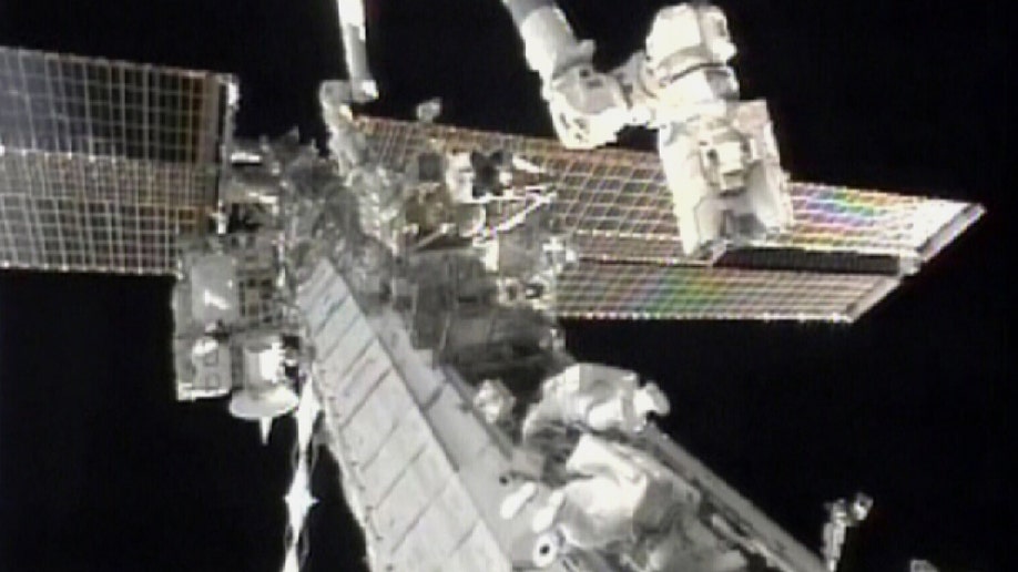 In this image taken from video and made available by NASA, astronauts Douglas Wheelock, top, and Tracy Caldwell Dyson work on the International Space Station to restore a crucial cooling system on Saturday Aug. 7, 2010. Their mission was to replace a broken ammonia coolant pump, a job considered so difficult that two spacewalks are required. (AP Photo/NASA)