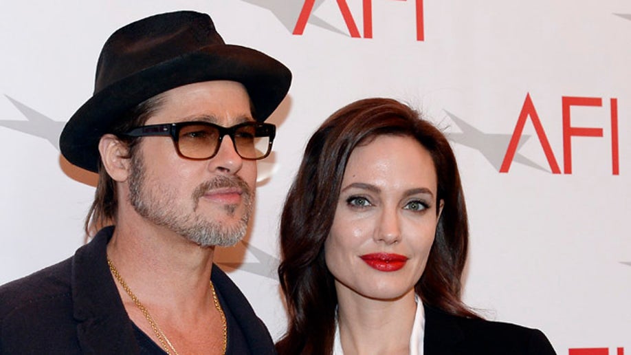 Actor Brad Pitt and actress/director Angelina Jolie pose at the AFI Awards 2014 honoring excellence in film and television in Beverly Hills, California, U.S. on January 9, 2015. REUTERS/Kevork Djansezian/File Photo - RTSOLP4