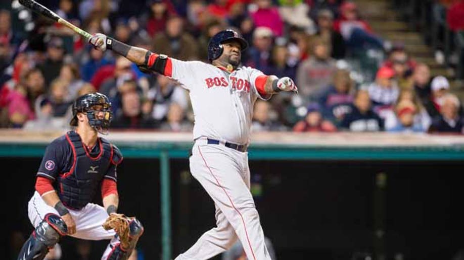 Boston Red Sox David Ortiz (L) watches the flight of his two run