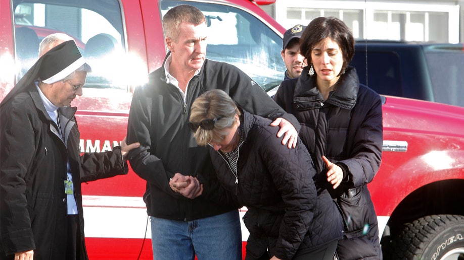 Relatives react outside Sandy Hook Elementary School following a shooting in Newtown, Connecticut, December 14, 2012. At least 27 people, including 18 children, were killed on Friday when at least one shooter opened fire at an elementary school in Newtown, Connecticut, CBS News reported, citing unnamed officials. REUTERS/Michelle McLoughlin (UNITED STATES - Tags: CRIME LAW EDUCATION)