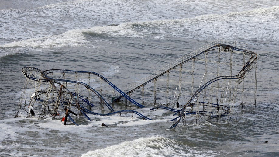 Waves wash over a roller coaster from a Seaside Heights, N.J. amusement park that fell in the Atlantic Ocean during superstorm Sandy on Wednesday, Oct. 31, 2012. New Jersey got the brunt of the massive storm, which made landfall in the state and killed six people. More than 2 million customers were without power as of Wednesday afternoon, down from a peak of 2.7 million. (AP Photo/Mike Groll)