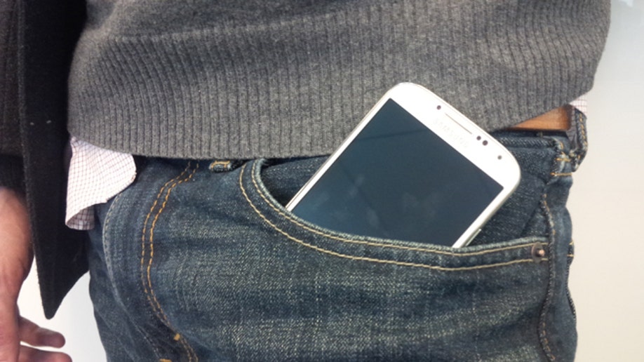 Pants with outlet phone pocket