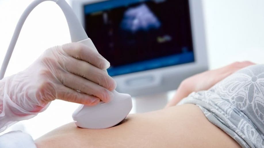 Woman gets sonogram done to detect pregnancy