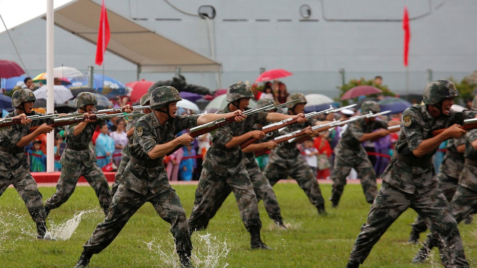 People's Liberation Army Navy soldiers perform at a naval base in Hong Kong, China July 8, 2017. REUTERS/Bobby Yip - RC1454D86220