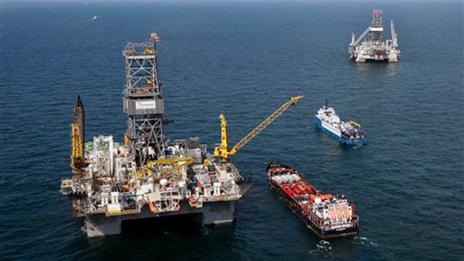 The Transocean Development Driller III, left, and the Transocean Development Driller II, right, the rigs drilling relief wells, are seen on the Gulf of Mexico near the coast of Louisiana Aug. 14. (AP Photo)