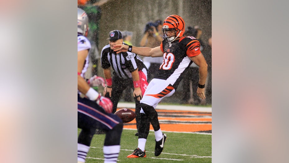 Not used to the attention, Kevin Huber and his 57-yard punt into downpour  helps save Bengals