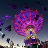 People enjoy a swing ride at the 185th Oktoberfest beer festival in Munich, Germany, September 27, 2018