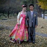 North Korean bride Ri Ok Ran, 28, and groom Kang Sung Jin, 32, pose for a portrait in Pyongyang, North Korea, October 14, 2014