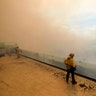 Fireflighters watch a brush fire burn on a hillside in Burbank, Calif., September 2