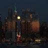 The full moon rising over 42nd Street on Friday evening as seen from Weehawken, NJ