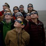 Students try to view a partial solar eclipse through thick fog at 'Halde Hoheward' in Herten, Germany,  March 20, 2015