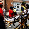 Medical workers transport a victim who was injured when a car drove through a group of counter protesters in Charlottesville, August 12