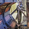 Painter/blaster Christopher Fuller removes a metal frame from the oven in preparation for powder coating  in the sandblast facility