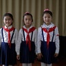 Sin Ji Ye, 9, An Rye Jong, 10, and Kim Ye Yon, 8 pose for a portrait as they attend a singing class in Pyongyang, North Korea, May 7, 2015