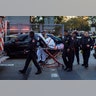 Emergency personnel carry a man into an ambulance after a terror attack in New York City, October 31