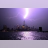 The Hudson River glows as lightning strikes One World Trade Center in New York City