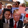 People hold a portrait of U.S. President Donald Trump during his public speech at Krasinski Square, in Warsaw, Poland