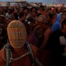 A participant wears a mask as he dances at the annual Burning Man arts and music festival in the Black Rock Desert of Nevada, August 29