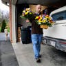 Man brings flowers to deceased coal miner