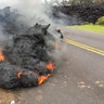 Lava from the Kilauea volcano moves across the road in the Leilani Estates in Pahoa, Hawaii, May 5, 2018