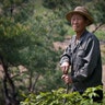 Village elder Kim Ri Jun, 77, poses for a portrait on Ryongyon-ri hill in Kujang county, North Korea, May 8, 2017